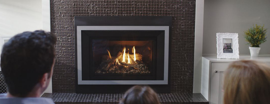 family in front of gas fireplace