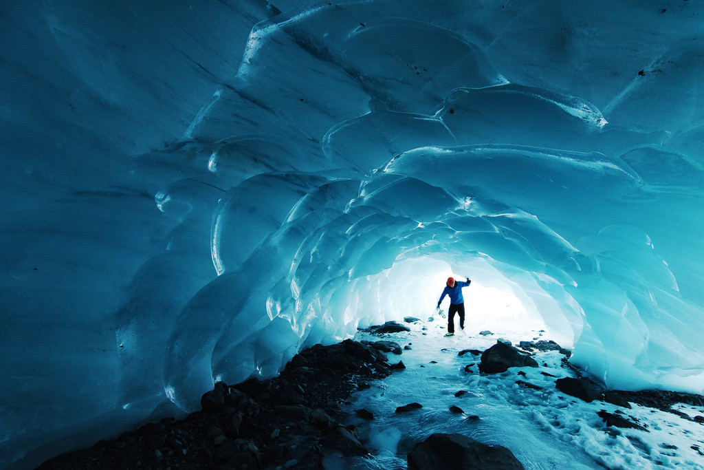 Image of a Man Standing at the Entrance of an Ice Cave
