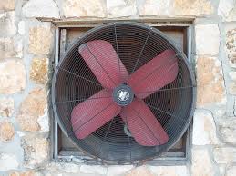Image of a Large Fan Mounted in a Stone Wall
